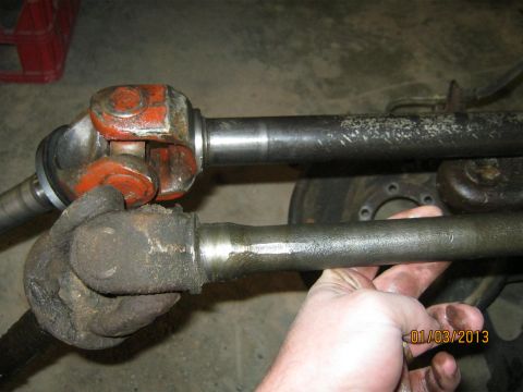 1970 Ford Bronco - A close-up shows two drive shafts, one appearing older and dirtier than the other.
