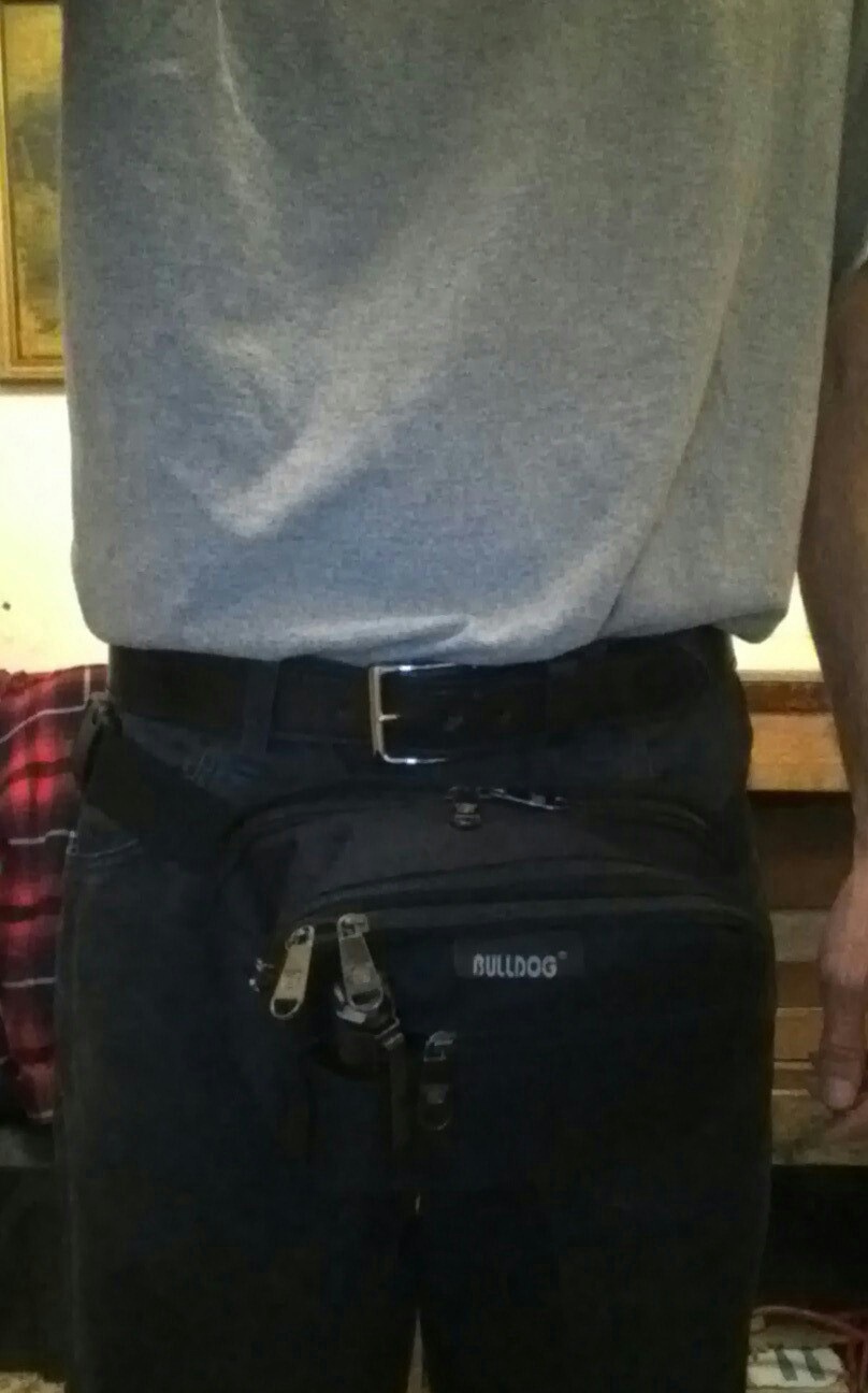 Black fanny pack with zippers and a "BULLDOG" logo worn by a person