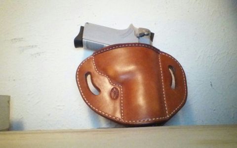 1993 Ford Bronco - A leather holster and a handgun are displayed against a textured wall.