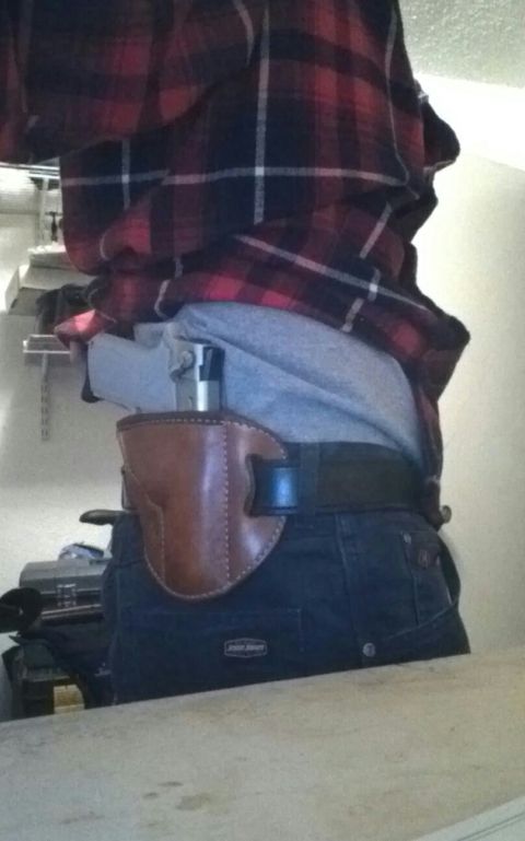 1993 Ford Bronco - A handgun is carried in a leather holster on a person's hip.