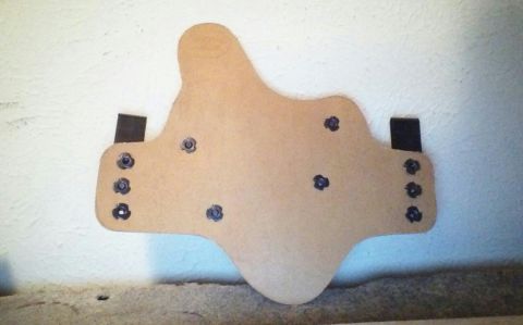 1993 Ford Bronco - A tan leather holster with multiple metal snaps is displayed against a textured wall.