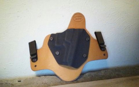 1993 Ford Bronco - This is a leather gun holster with a black insert and metal clips.