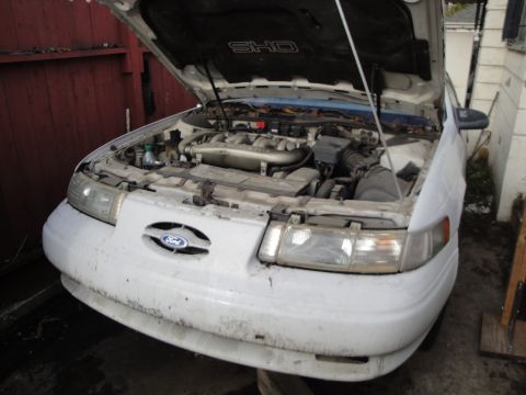 1992 Ford Taurus - Front view of a 1992 Ford Taurus SHO, hood up, revealing the engine compartment.