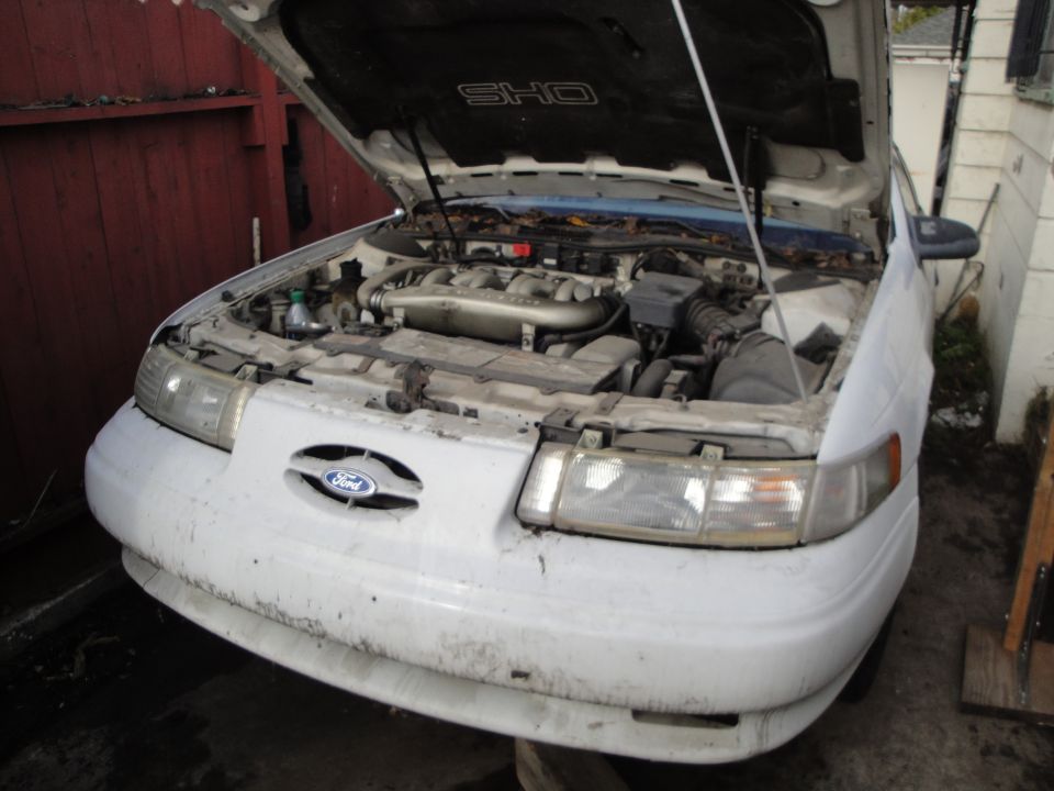 1992 Ford Taurus SHO with hood open, showing engine bay. Ford logo on grille