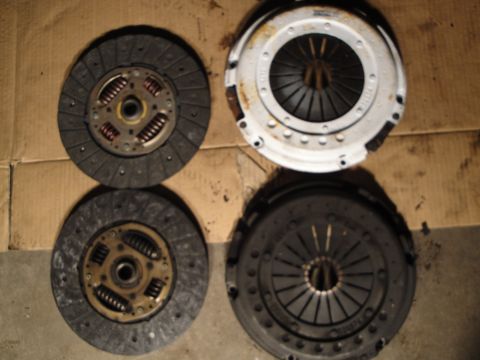 1992 Ford Taurus - A set of clutch components, including two clutch discs and two pressure plates, are displayed.