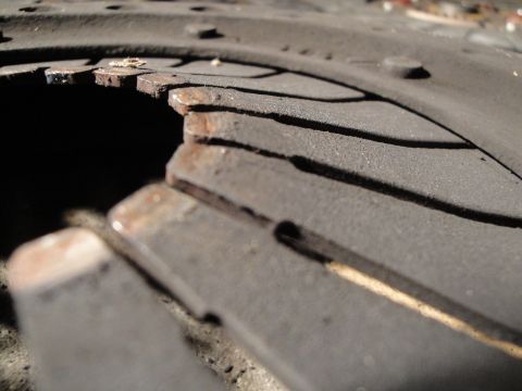 1992 Ford Taurus - The friction material on this clutch disc is severely worn and damaged, exposing the metal underneath.