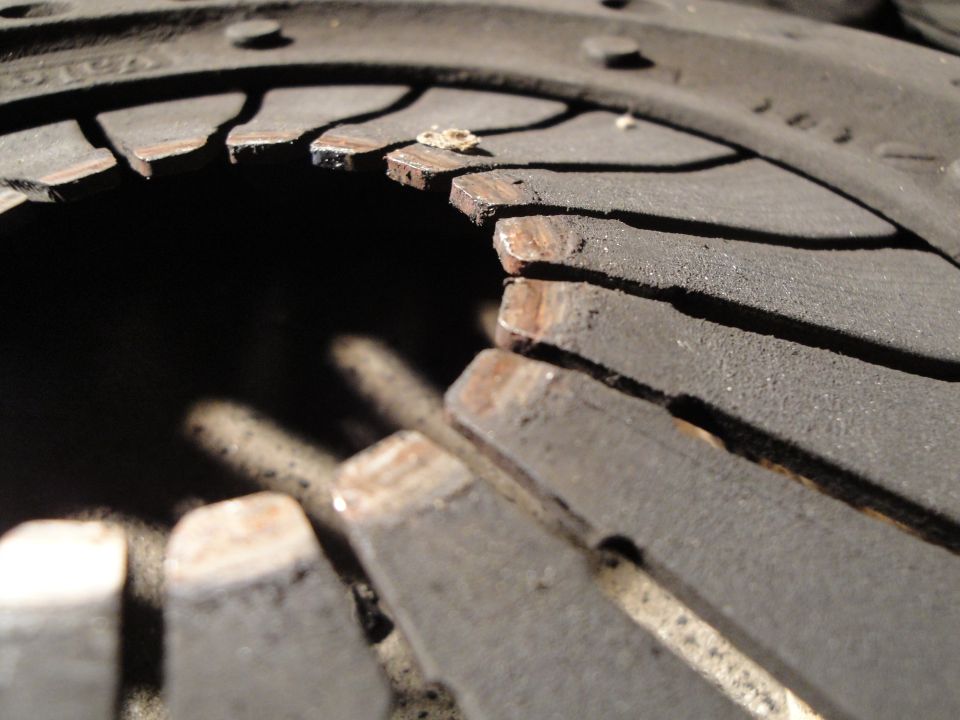 Clutch disc with worn friction material and visible metal backing plates