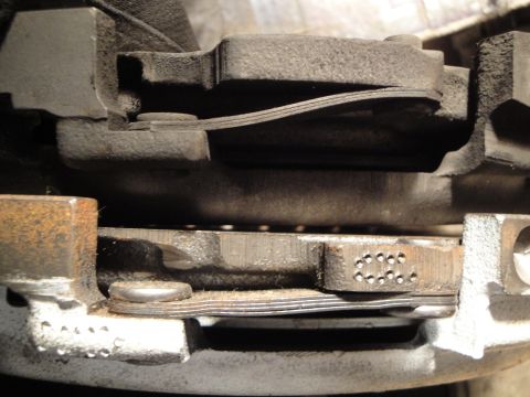 1992 Ford Taurus - A detailed view of a vehicle's clutch assembly, showing wear on the friction disc and pressure plate.