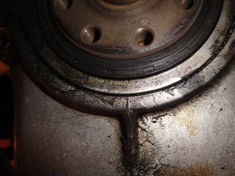 1992 Ford Taurus - Engine crankshaft seal showing signs of wear and oil leakage.