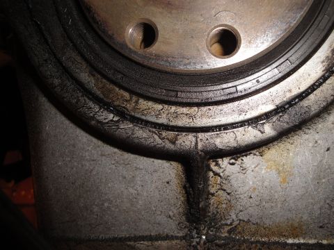 1992 Ford Taurus - This image shows a worn engine seal with visible cracks and oil leakage, indicating a need for replacement.