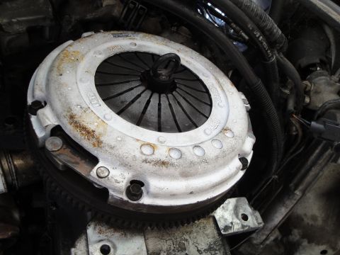 1992 Ford Taurus - A close-up view of a vehicle's clutch assembly, showing wear and some legible part numbers.