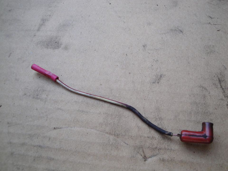 Spark plug wire with red boot and pink connector