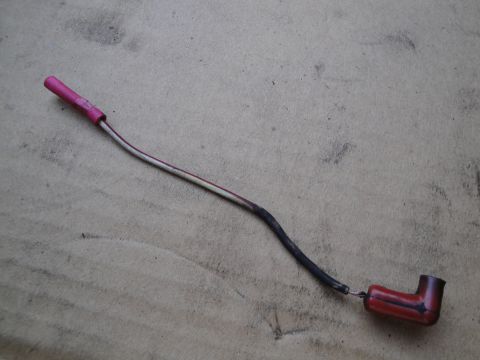 1992 Ford Taurus - A single automotive wire with red boot connector and insulation is shown against a textured background.