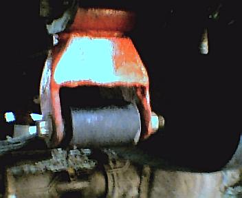 1984 Ford Bronco - Close-up of a vehicle's suspension component, with the Supermotors logo in the corner.