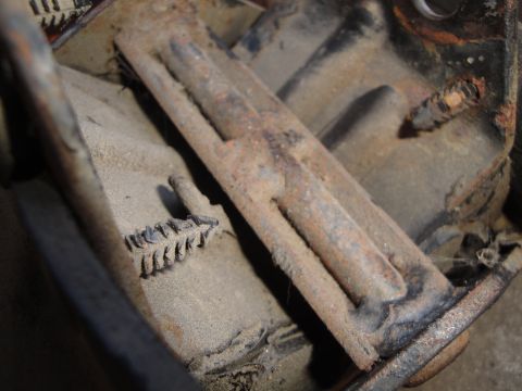 1992 Ford Taurus - Close-up of a heavily corroded clutch fork, covered in dust and debris.
