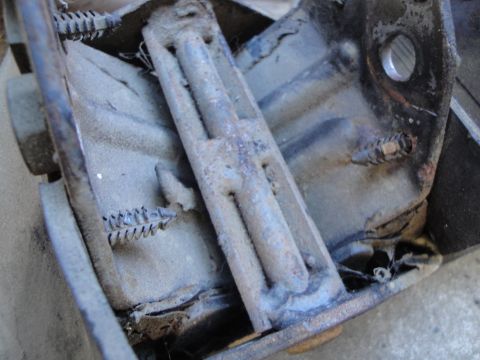1992 Ford Taurus - Close-up view of a worn clutch pedal assembly, showing springs and a metal bracket.