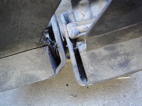 1992 Ford Taurus - Close-up of damaged rubber bumper parts showing wear and tear.