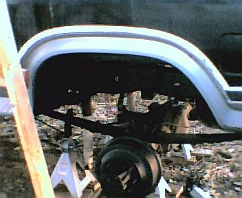 1984 Ford Bronco - Close-up of a rear axle assembly supported by jack stands, with a SuperMotors.net watermark.