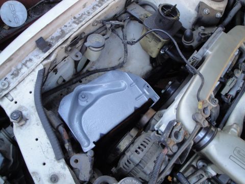 1992 Ford Taurus - Close-up view of the engine bay of a 1992 Ford Taurus, showing the clutch assembly and other engine components.