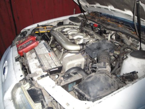 1992 Ford Taurus - The engine bay of a car is shown with the hood open, revealing the V6 engine and various components.