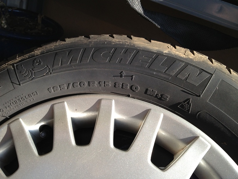 Michelin tire with 195/60R15 88Q M+S markings on silver alloy wheel