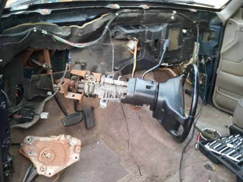 1994 Ford Bronco - The interior of a 1994 Ford Bronco shows a disassembled dashboard and steering column, with wiring exposed.