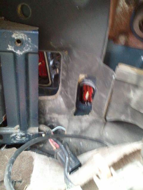 1994 Ford Bronco - Exposed wiring and a red component are visible in the dashboard of a vehicle.