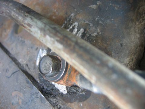 1992 Ford Bronco - A close-up view of a ground wire connection, showing a bolt and some surface rust.