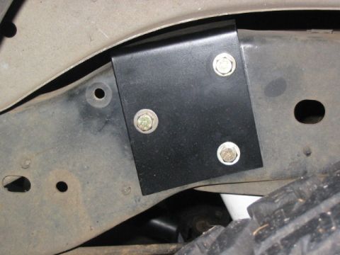 1995 Ford Bronco - A bracket is attached to the vehicle's frame, showing part of the suspension and tire.