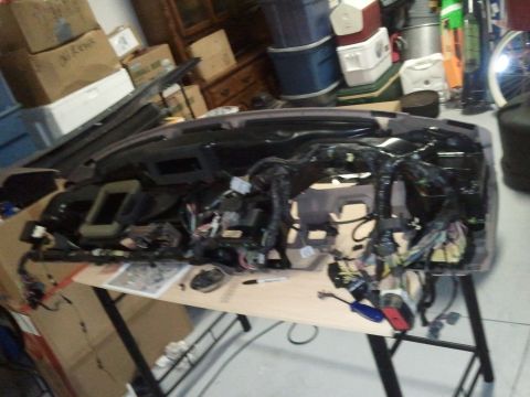 1994 Ford Bronco - A complex wiring harness from a vehicle's dashboard is laid out on a table for inspection or repair.