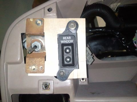 1994 Ford Bronco - Rear window switch assembly with up and down buttons, mounted on a bracket.