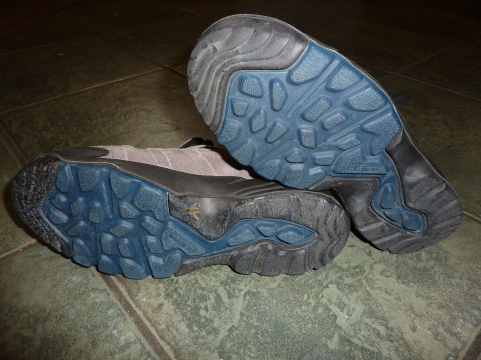 Soles of two shoes with blue and black tread