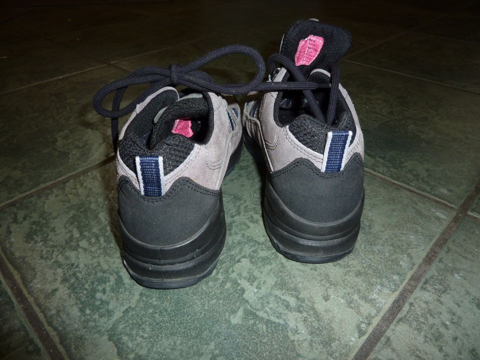 Pair of gray and black athletic shoes with black laces tied together