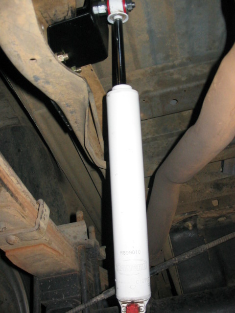 1995 Ford Bronco - Close-up of a white rear shock absorber, part number RS29010, mounted to vehicle suspension.