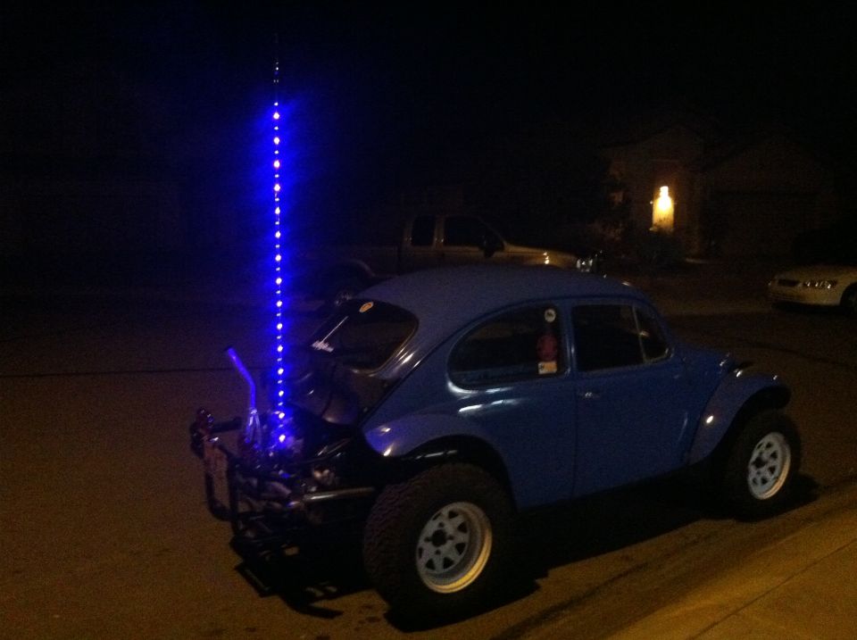 Blue Baja Bug modified Volkswagen Beetle with off-road tires and a blue LED whip antenna