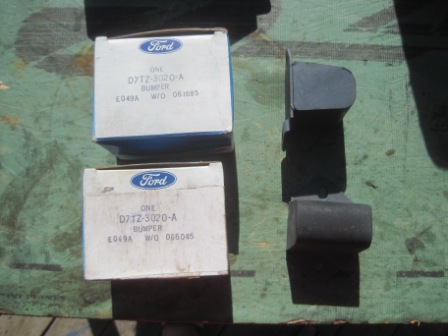 1993 Ford Bronco - Two Ford boxes and a bumper part are displayed on a green surface.