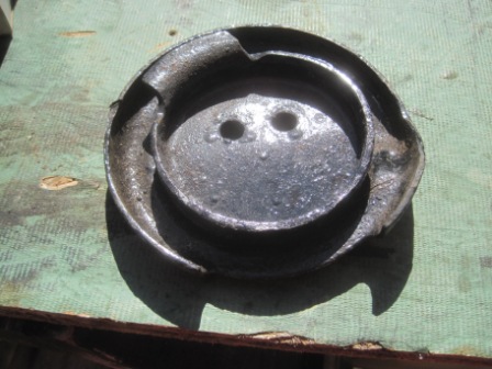 1993 Ford Bronco - This is a worn metal part with two holes, likely a component from a vehicle.