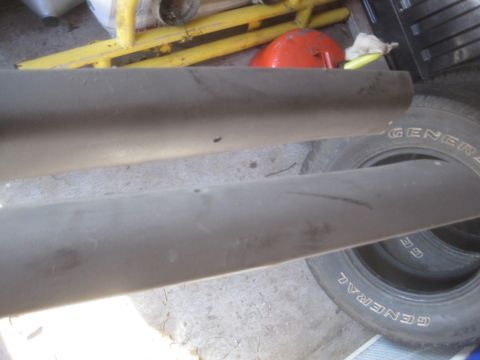 1993 Ford Bronco - Close-up of vehicle trim pieces and a tire with 'GENERAL' branding visible on it, in a garage setting.