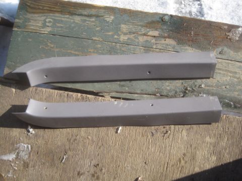 1993 Ford Bronco - These two gray plastic trim pieces are for sale, but their specific vehicle origin is not identifiable from the image.