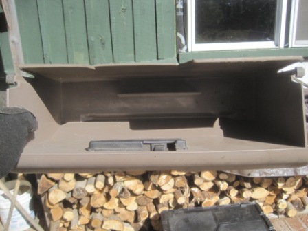 1993 Ford Bronco - The interior of a vehicle's glove box is shown, with a pile of firewood visible underneath.