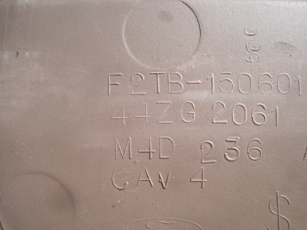 1993 Ford Bronco - Close-up of a part showing embossed alphanumeric identifiers and a SuperMotors logo.