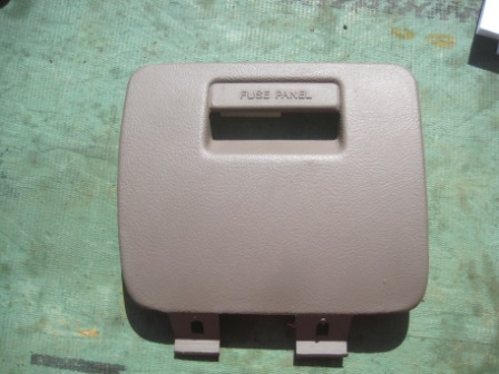 1993 Ford Bronco - This is a tan fuse panel door with 'FUSE PANEL' text visible. It is a part for a vehicle.