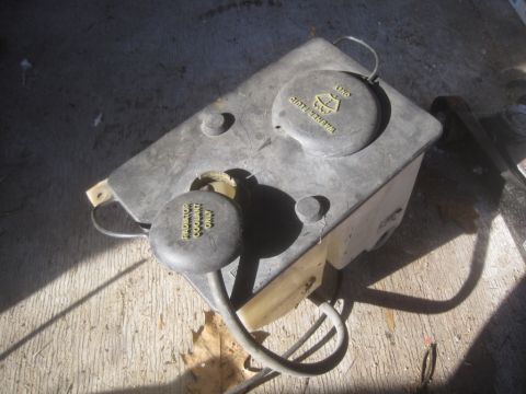 1993 Ford Bronco - This is a vehicle's windshield washer fluid reservoir, showing labels for washer fluid and coolant.
