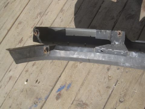 1993 Ford Bronco - This is a front bumper part, likely for a truck or SUV, shown on a wooden deck. No vehicle is visible.