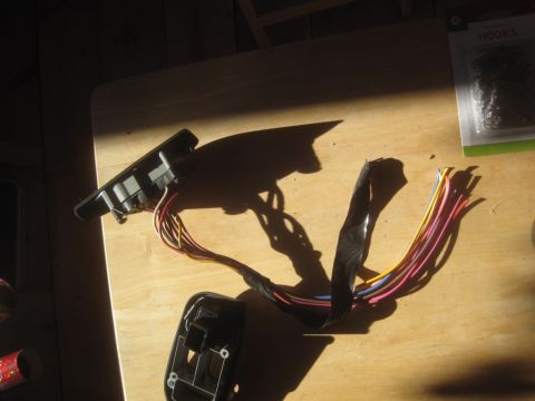 1993 Ford Bronco - A disassembled automotive switch and its associated wiring harness are shown on a table.