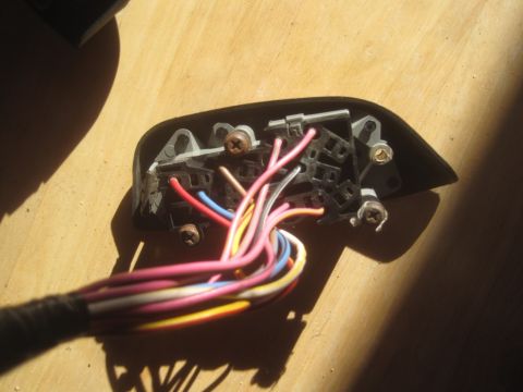 1993 Ford Bronco - A close-up view of a vehicle's wiring harness connector with numerous colored wires.