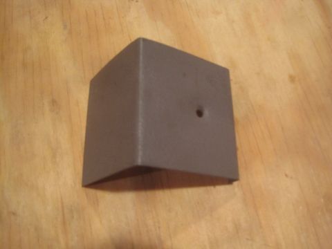 1993 Ford Bronco - This brown plastic interior trim piece, likely from a vehicle's cabin, is shown on a wooden background. It features a small hole on one sid…