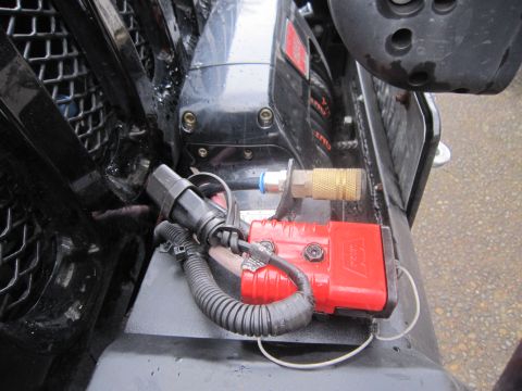 2008 Jeep Wrangler - A red winch control box is mounted near a vehicle's grille, connected to an air compressor fitting.