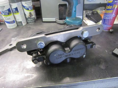 2008 Jeep Wrangler - A close-up view of a brake caliper assembly, likely for a vehicle upgrade, with visible part numbers and mounting hardware.