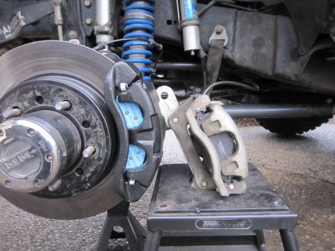 2008 Jeep Wrangler - Close-up of a Jeep Wrangler's front brake assembly, showing a new caliper and rotor.